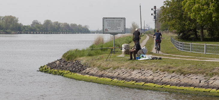 Radfahrer und Angler am Kanal